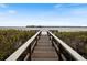Wooden dock extending to calm water with distant shoreline at 1111 N Bayshore Blvd # F6, Clearwater, FL 33759
