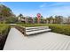 White bench on a wooden dock with water view at 1111 N Bayshore Blvd # F6, Clearwater, FL 33759