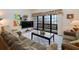 Living room with water view, comfortable sofas, and coffee table at 1111 N Bayshore Blvd # F6, Clearwater, FL 33759