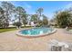 Community pool with lounge chairs and waterfront view at 1111 N Bayshore Blvd # F6, Clearwater, FL 33759