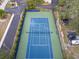 Aerial view of a blue tennis court with green perimeter at 1111 N Bayshore Blvd # F6, Clearwater, FL 33759