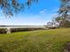 Serene waterfront view with grassy area, dock, and kayaks at 1111 N Bayshore Blvd # F6, Clearwater, FL 33759
