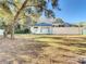 Large backyard with mature trees and grassy area at 11620 Eastern Star Ct, New Port Richey, FL 34654