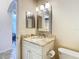 Bathroom with granite countertop, updated vanity, and a mirrored medicine cabinet at 11620 Eastern Star Ct, New Port Richey, FL 34654