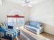 Comfortable bedroom with blue and white couch and ottoman at 11620 Eastern Star Ct, New Port Richey, FL 34654