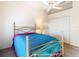 Bedroom with a metal bed frame, teal bedding, and a double door closet at 11620 Eastern Star Ct, New Port Richey, FL 34654