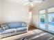 Bedroom with pool view, featuring a comfy couch and access to the outdoors at 11620 Eastern Star Ct, New Port Richey, FL 34654