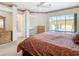 Primary bedroom with pool view and wooden furniture at 11620 Eastern Star Ct, New Port Richey, FL 34654