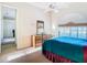 Bright bedroom with a dresser, ceiling fan, and an arched window at 11620 Eastern Star Ct, New Port Richey, FL 34654