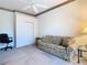Bright bedroom with ceiling fan and closet, featuring a sofa at 11620 Eastern Star Ct, New Port Richey, FL 34654