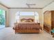 Primary bedroom with wooden furniture and access to the patio at 11620 Eastern Star Ct, New Port Richey, FL 34654