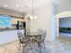 Eat-in kitchen area with glass-top table and wrought iron chairs at 11620 Eastern Star Ct, New Port Richey, FL 34654