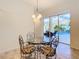 Cozy breakfast nook with glass-top table and wrought iron chairs, overlooking pool at 11620 Eastern Star Ct, New Port Richey, FL 34654