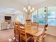 Spacious dining room with large wooden table and chairs, near living room at 11620 Eastern Star Ct, New Port Richey, FL 34654