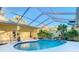Enclosed heated pool with a tranquil waterfall feature at 11620 Eastern Star Ct, New Port Richey, FL 34654