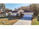 Single-story house with a two-car garage and landscaped yard at 11620 Eastern Star Ct, New Port Richey, FL 34654