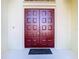 Elegant double red front doors with a welcoming mat at 11620 Eastern Star Ct, New Port Richey, FL 34654