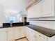 Modern kitchen with white cabinets and granite countertops at 11620 Eastern Star Ct, New Port Richey, FL 34654