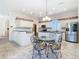 Bright kitchen with island, stainless steel appliances, and eat-in area at 11620 Eastern Star Ct, New Port Richey, FL 34654