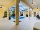 Inviting pool area with covered patio, lush landscaping, and a built-in grill at 11620 Eastern Star Ct, New Port Richey, FL 34654
