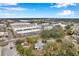 Aerial view showcasing the home's proximity to various businesses and a large warehouse at 1230 32Nd N St, St Petersburg, FL 33713