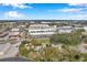 Aerial view showcasing the home's proximity to various businesses and a large warehouse at 1230 32Nd N St, St Petersburg, FL 33713