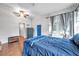 Bedroom with blue bedding and wood flooring, near a blue door at 1230 32Nd N St, St Petersburg, FL 33713