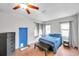 Bright bedroom with blue bedding and a blue door at 1230 32Nd N St, St Petersburg, FL 33713