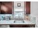 Kitchen sink and granite countertop with a view to the backyard at 1230 32Nd N St, St Petersburg, FL 33713