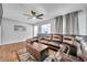 Spacious living room featuring a large leather sectional sofa and a coffee table at 1230 32Nd N St, St Petersburg, FL 33713