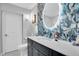 Elegant bathroom with a modern vanity, unique tile work, and large mirror at 150 Sage Rd, Crystal Beach, FL 34681