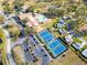 Aerial view of community with tennis courts, pool, and clubhouse at 1658 Macdonnell Ct, Palm Harbor, FL 34684