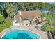 Resort-style pool with lounge chairs and clubhouse view at 1658 Macdonnell Ct, Palm Harbor, FL 34684