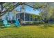 Screened patio, lush lawn, and water view at 22 Penzance Ct, Safety Harbor, FL 34695