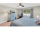 Main bedroom with blue armoire and exercise bike at 22 Penzance Ct, Safety Harbor, FL 34695