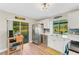 Updated kitchen with stainless steel appliances and white cabinets, overlooking a patio at 22 Penzance Ct, Safety Harbor, FL 34695