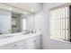 Clean bathroom with white cabinets and a large mirror at 2250 Rio De Janeiro Ave, Punta Gorda, FL 33983