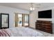 Main bedroom with pool view, large dresser, and ceiling fan at 2250 Rio De Janeiro Ave, Punta Gorda, FL 33983