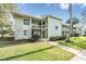 Two-story condo building with lush landscaping and walkway at 232 Caryl Way # 232, Oldsmar, FL 34677