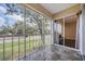 Screened balcony overlooking a lush green space at 232 Caryl Way # 232, Oldsmar, FL 34677