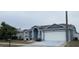 Two-car garage, manicured lawn and curb appeal at 23917 Pow Wow Dr, Lutz, FL 33559