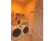 Convenient laundry room with washer, dryer, and extra storage at 23917 Pow Wow Dr, Lutz, FL 33559