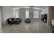 Spacious living room with tile floors and ample natural light at 23917 Pow Wow Dr, Lutz, FL 33559