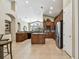 Spacious kitchen boasts granite countertops, wood cabinets, and an island at 26722 Winged Elm Dr, Wesley Chapel, FL 33544