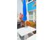 Outdoor patio with table, umbrella, and vibrant flowers at 320 Medallion Blvd # D, Madeira Beach, FL 33708