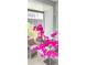 Relaxing patio area with wicker furniture and vibrant flowers at 320 Medallion Blvd # D, Madeira Beach, FL 33708