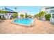 Community pool with plenty of lounge chairs at 320 Medallion Blvd # D, Madeira Beach, FL 33708