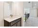 Stylish bathroom with dark vanity and a view of a loft area at 33764 Ocean Spray Ln, Wesley Chapel, FL 33543