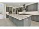 Gourmet kitchen boasts gray cabinets, marble countertops, and high-end appliances at 33764 Ocean Spray Ln, Wesley Chapel, FL 33543