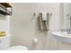 Clean and simple half bathroom with white sink and neutral color palette at 36401 Camp Fire Ter, Zephyrhills, FL 33541